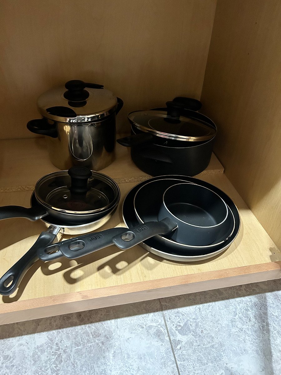 Fully stocked with pots and pans for cooking.