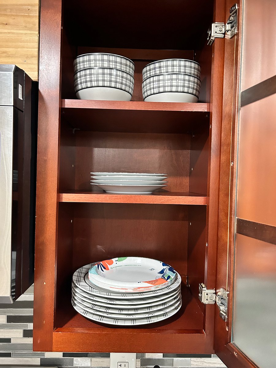 Fully stocked with plates, bowls, and dishes.