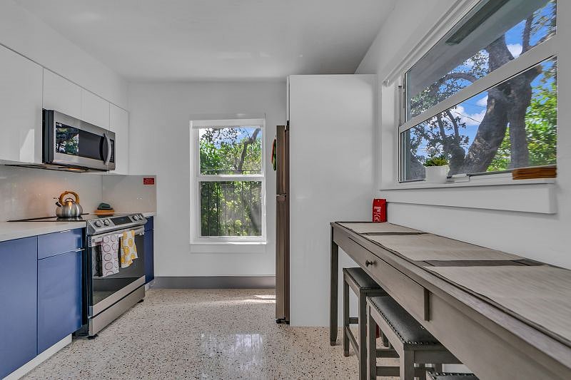 Very Spacious Kitchen with all the amenities: Full sized range, fridge, microwave, coffee maker and toaster, cooking utensils, mugs, cups, silverware, pots and pans.