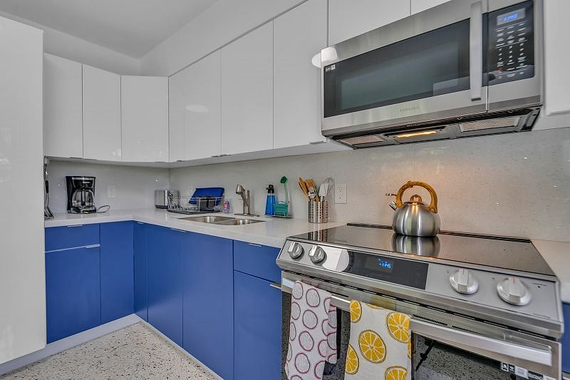 Very Spacious Kitchen with all the amenities: Full sized range, fridge, microwave, coffee maker and toaster, cooking utensils, mugs, cups, silverware, pots and pans.