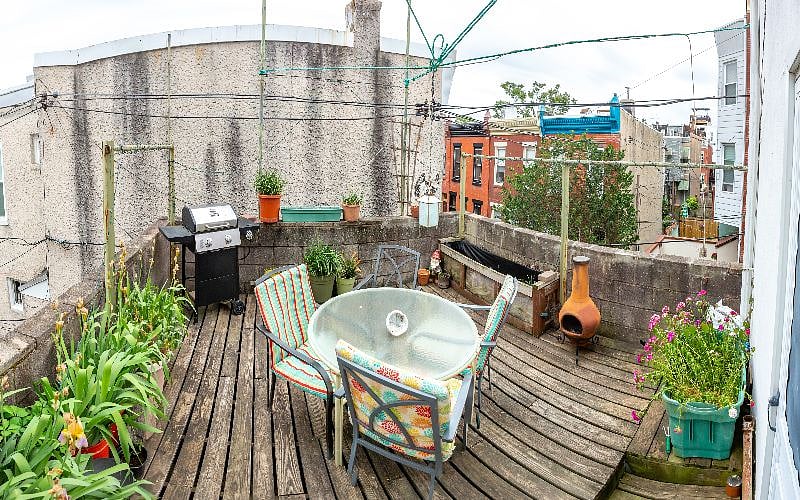 The deck off the office/ second bedroom gets a ton of light. I haven't planted anything yet this year. Below the deck is a small shared garage space good for bikes or a scooter. We have a container garden most years. Table, chairs, and grill.