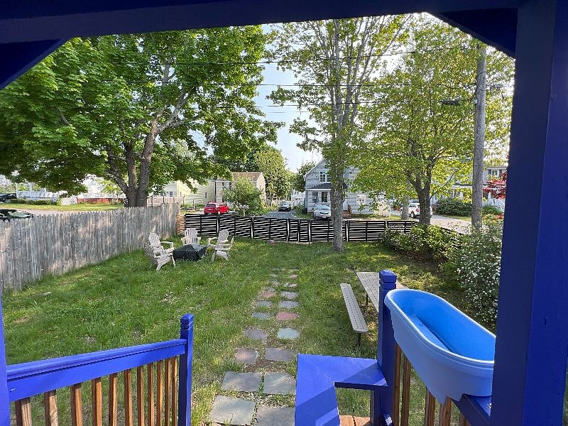Fenced yard with fire pit, charcoal grill and picnic table