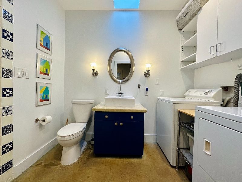 Bathroom with full-sized washer and dryer