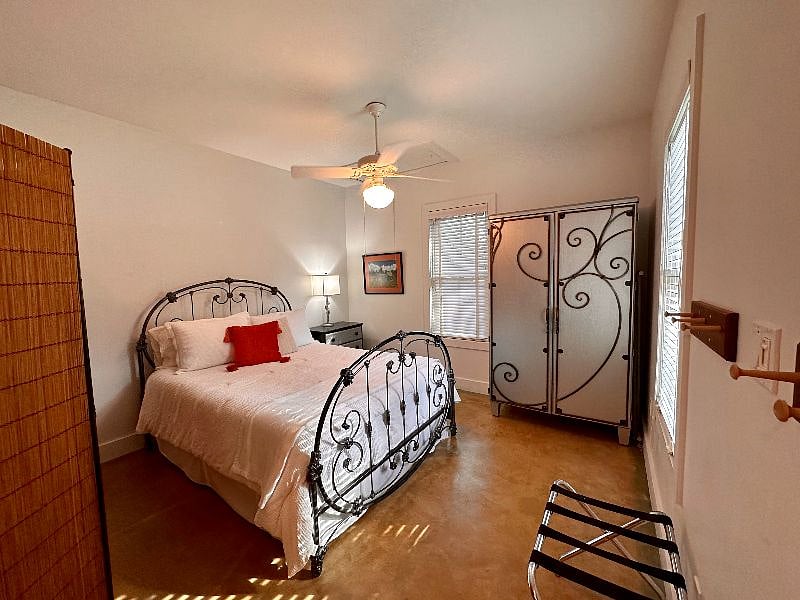 Bedroom with a queen bed and armoire