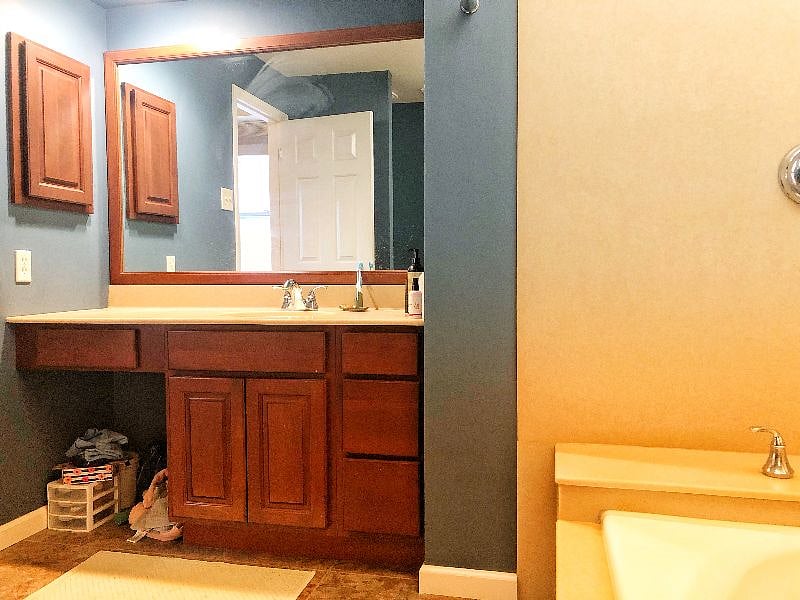 Master bathroom cabinets (excuse the stuff, it'll be gone!). Toilet has bidet feature as well. 