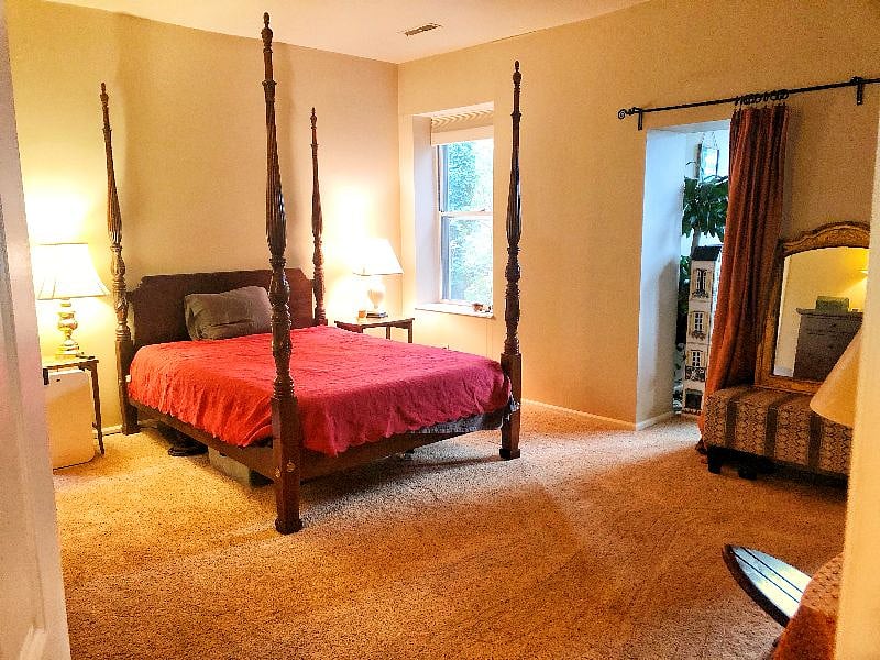Master bedroom. Bed has electric lift of head and feet for added end of day comfort / easy reading-in-bed set up. Just past the mirror is a second sunroom office --> 