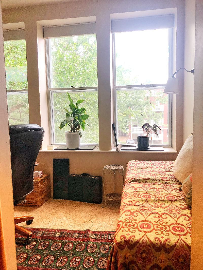 Master bedroom sunroom / office looking out on back shared condominium yard (with picnic table)