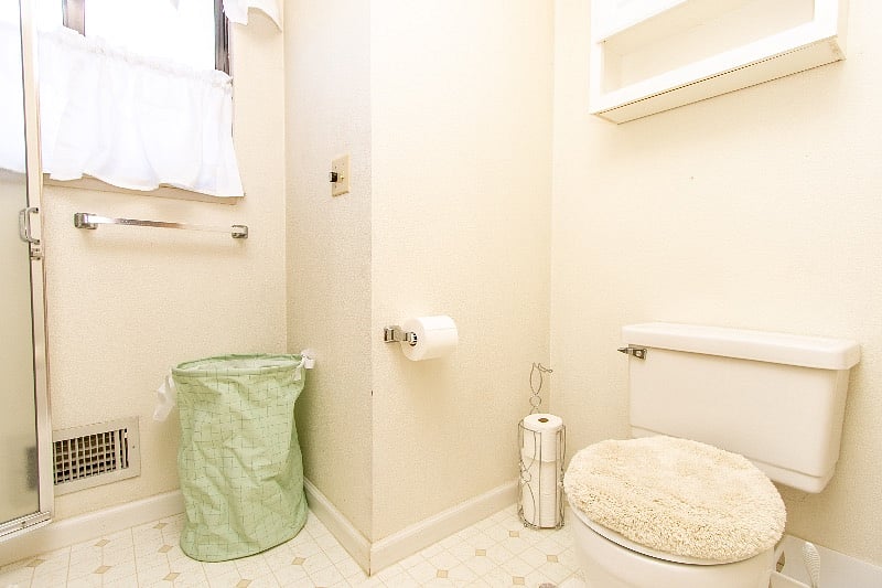 Bathroom toilet and a stand up shower..with a sliding pocket door.