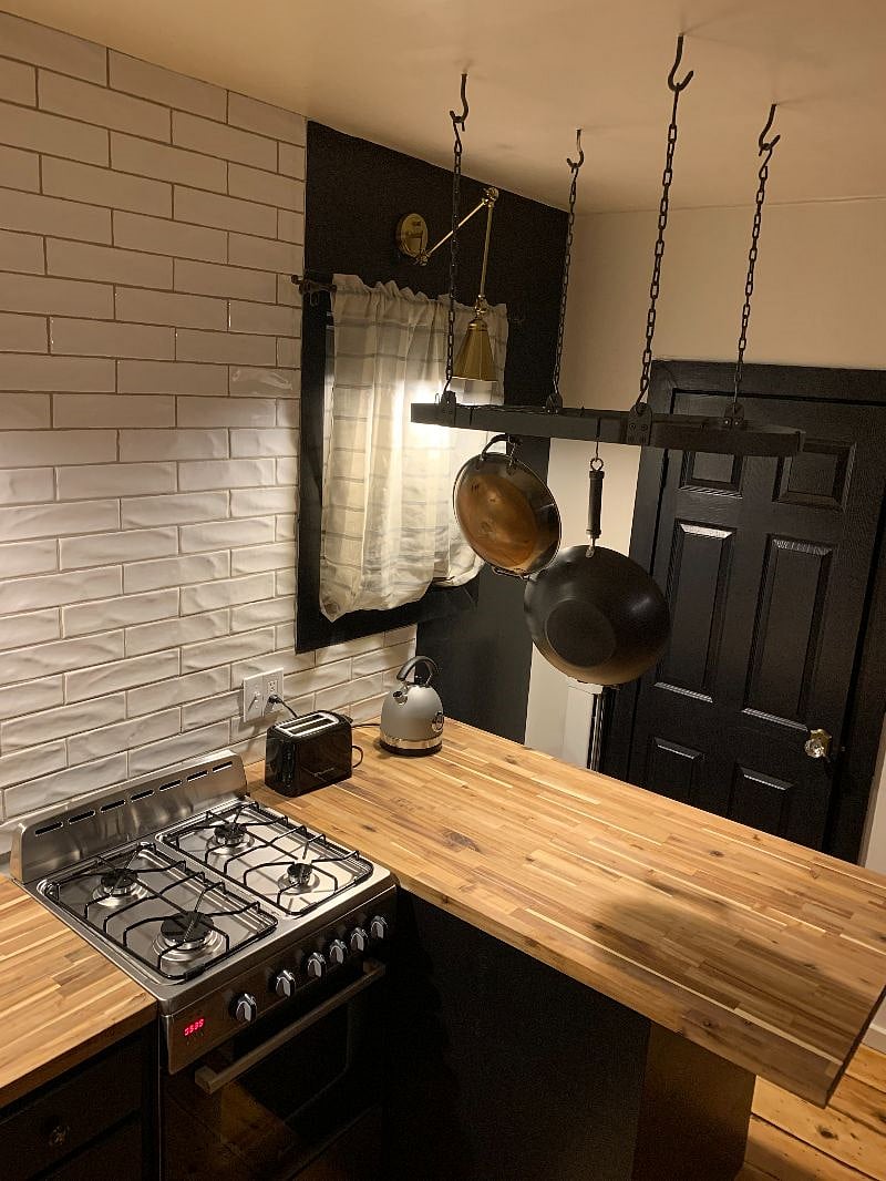 Kitchen island also holds the washer and dryer underneath.