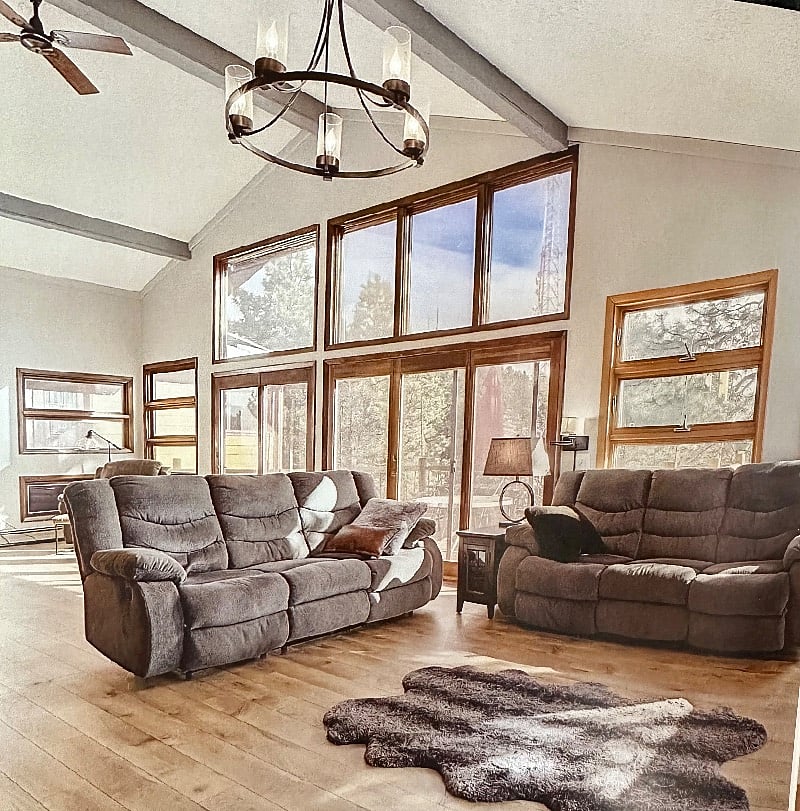 Two reclining sofas in living room with 65 smart tv