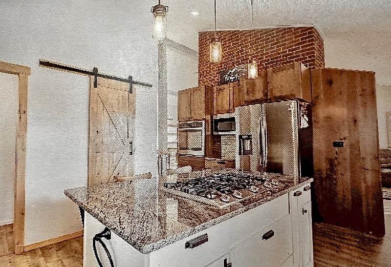 Beautiful updated kitchen with gas cooktop, electric convection oven. Large pantry behind barn door.