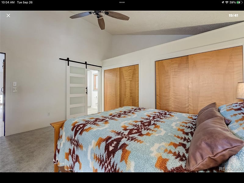 Main floor master bedroom with queen bed and attached bath, his and hers closets and dresser.