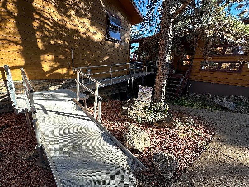 Front entrance with handicap ramp from driveway.