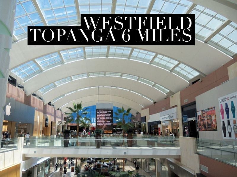Westfield Topanga 6 miles west.  Best shopping.  Great stores, food and movies in one place. 