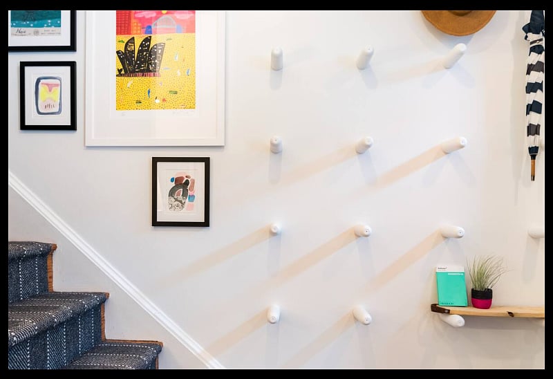 Entryway gallery wall and coat hook pegs