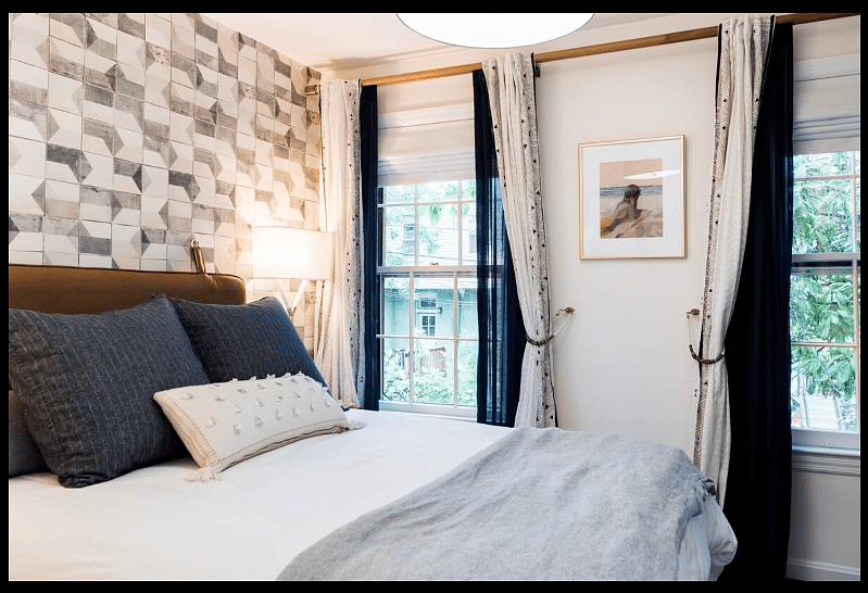 Primary bedroom with queen bed and black out window shades
