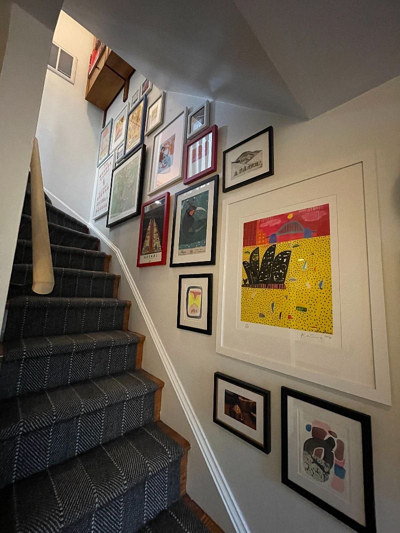 Gallery wall leading up stairs to bedrooms