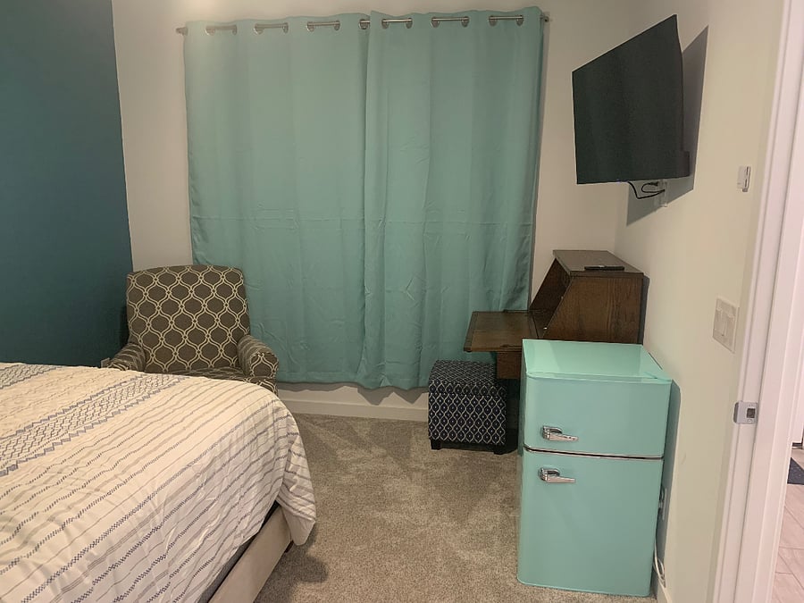 Rocking chair, ottoman, desk with storage, mini fridge/freezer, smart TV, blackout shades