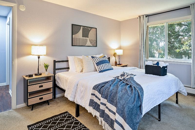 Escape to a haven of tranquility in our bedroom adorned with room darkening shades and expansive windows, allowing an abundance of natural light to flood in. The luxurious king size bed and spacious layout create an inviting atmosphere, while the sound machine and ear plugs ensure a peaceful night's sleep. Stay connected effortlessly with the convenient USB outlets on the lamps and the extra charging cords available, and enjoy ample storage space in the large closet to keep your belongings organized and out of sight.