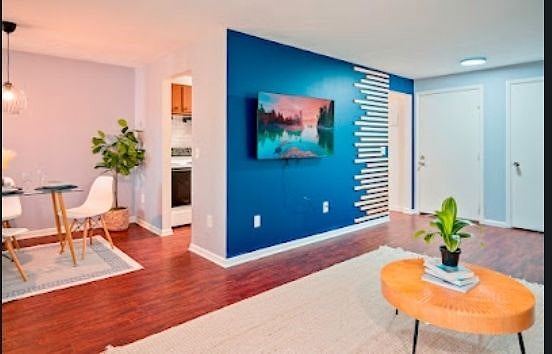 Welcome to your new apartment! As you step inside, you'll be greeted by a stylish living room designed for ultimate comfort and relaxation and admire the sleek smart TV mounted on a wall adorned with natural wood accents.