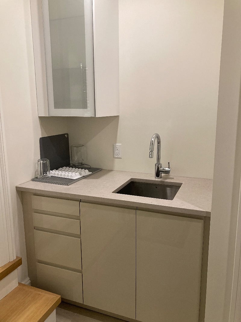 Kitchenette sink area with designer dishes.