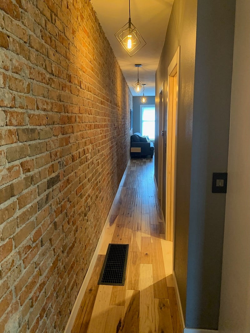 Hallway looking toward the living room. Bedrooms and bathroom are on the right. 