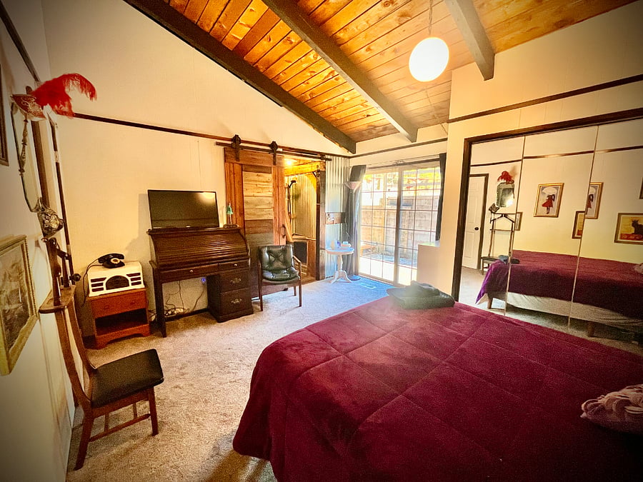 Master bedroom with private bathroom entry and private entrance and exit to outside