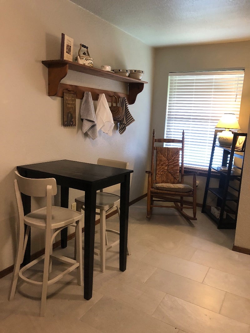 Bar height table and sitting area by window.