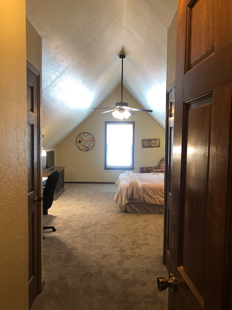 Spacious master bedroom with walk-in closet and desk/chair and Smart TV (on the left).