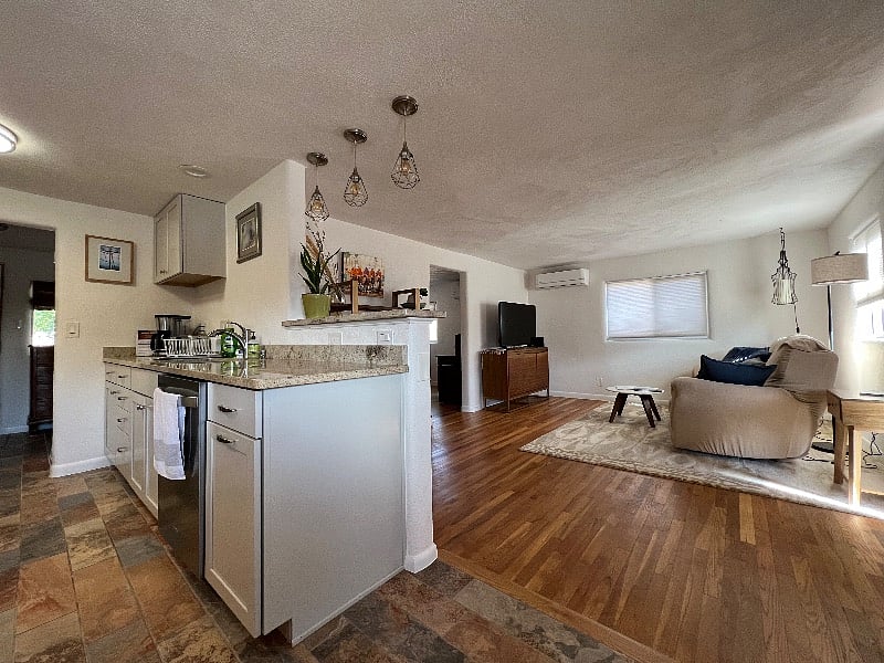 Sitting at dining table looking into living room and entrance to study