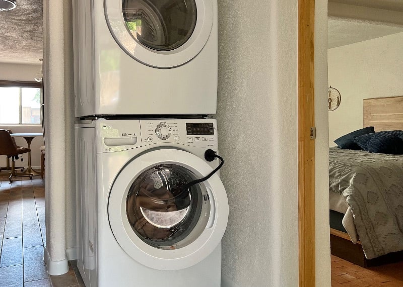 Washer and dryer by back door, peek into master bedroom and kitchen