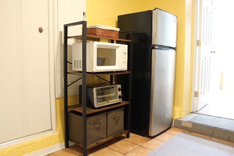 kitchen with refrigerator, freezer, microwave, toaster oven