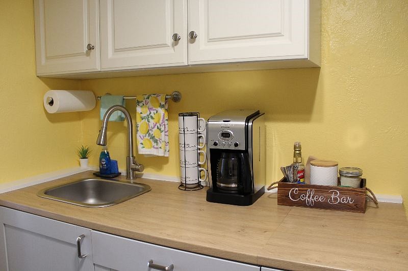 kitchen with coffee, coffee maker, tea, hot plate, dishes, cups, glasses, utensils, pots and pans
