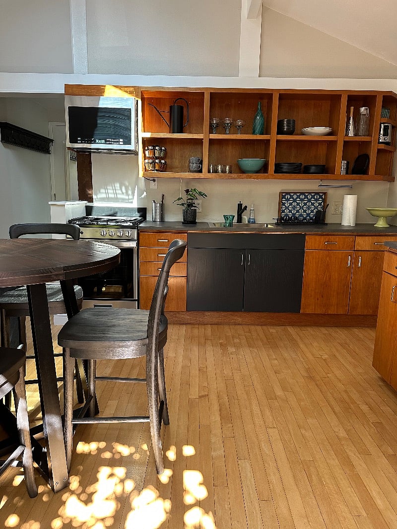 Spacious kitchen with new GE gas range and microwave.  Counter height table with comfortable modern farmhouse style chairs.C