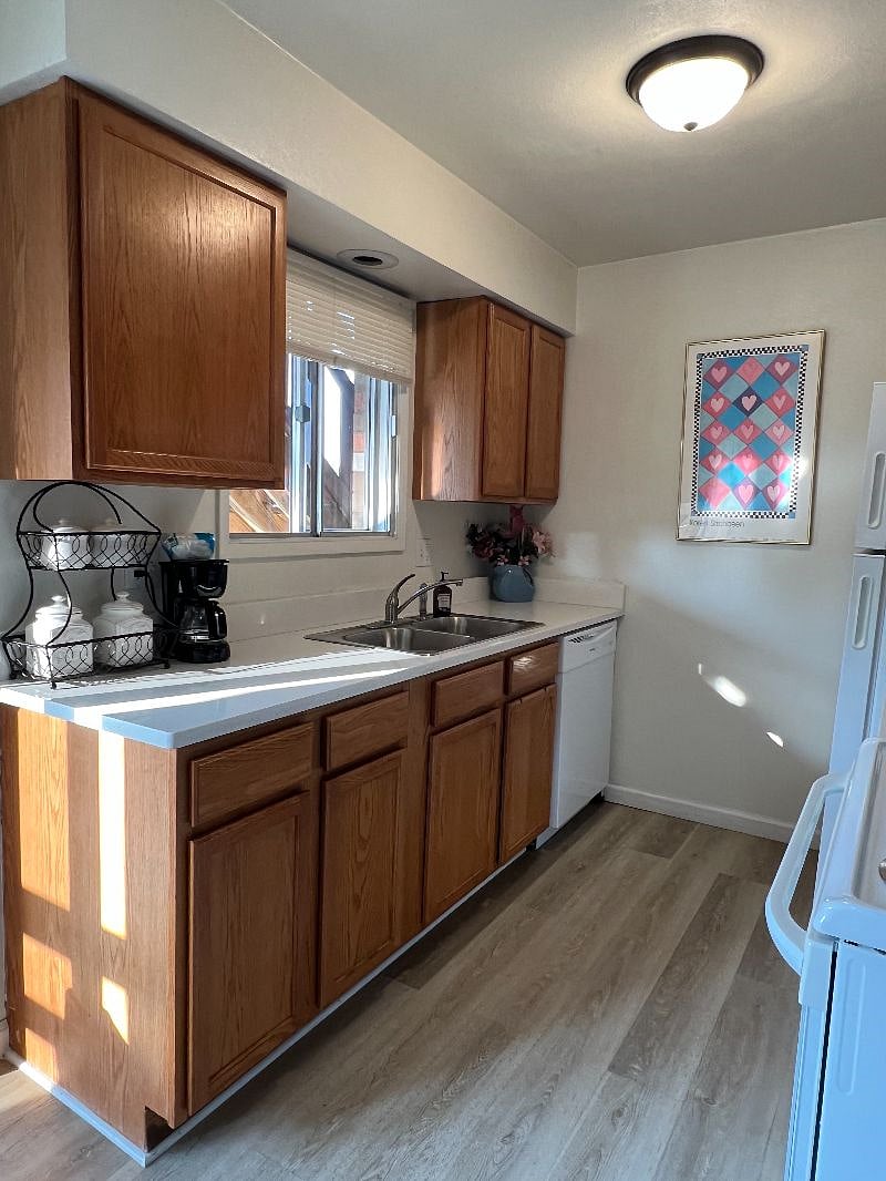 Kitchen space includes a double-sided sink with a garbage disposal, stove and oven, microwave, full-sized fridge and freezer, dishwasher and lots of cabinet space.