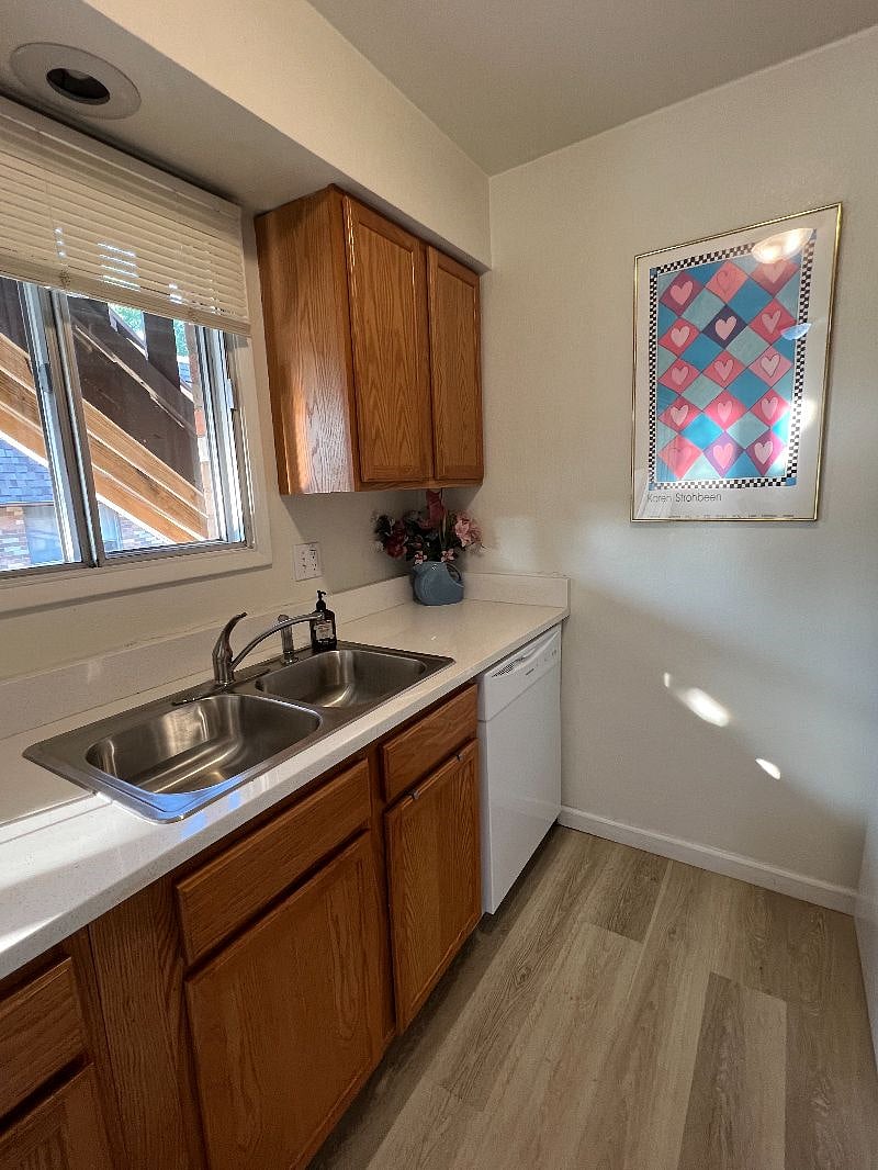 Kitchen space includes a double-sided sink with a garbage disposal, stove and oven, microwave, full-sized fridge and freezer, dishwasher and lots of cabinet space.