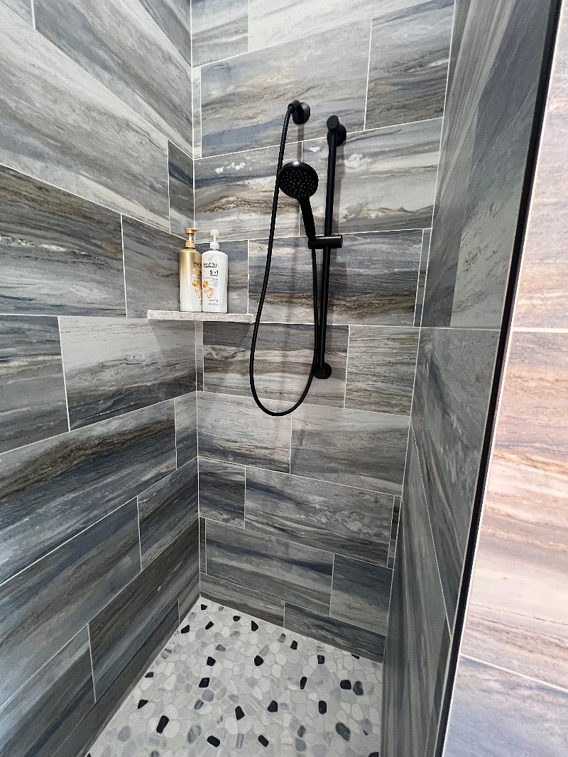 Walk in shower with no glass. But appreciate if you would squeegee tile that is wet as our water her is very hard and water spots easily.