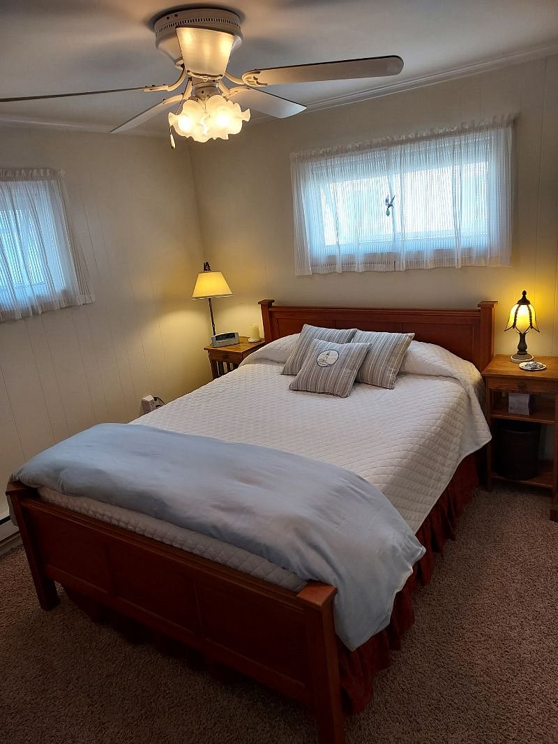 This bedroom is called The Lighthouse Room. Queen bed. Two windows. One large closet.
