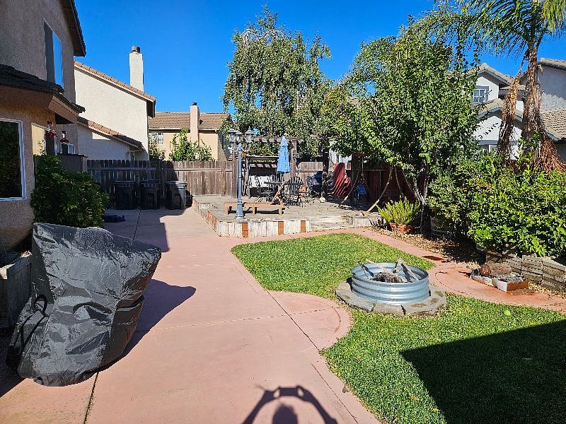 Shared backyard with bbq and fire pit.