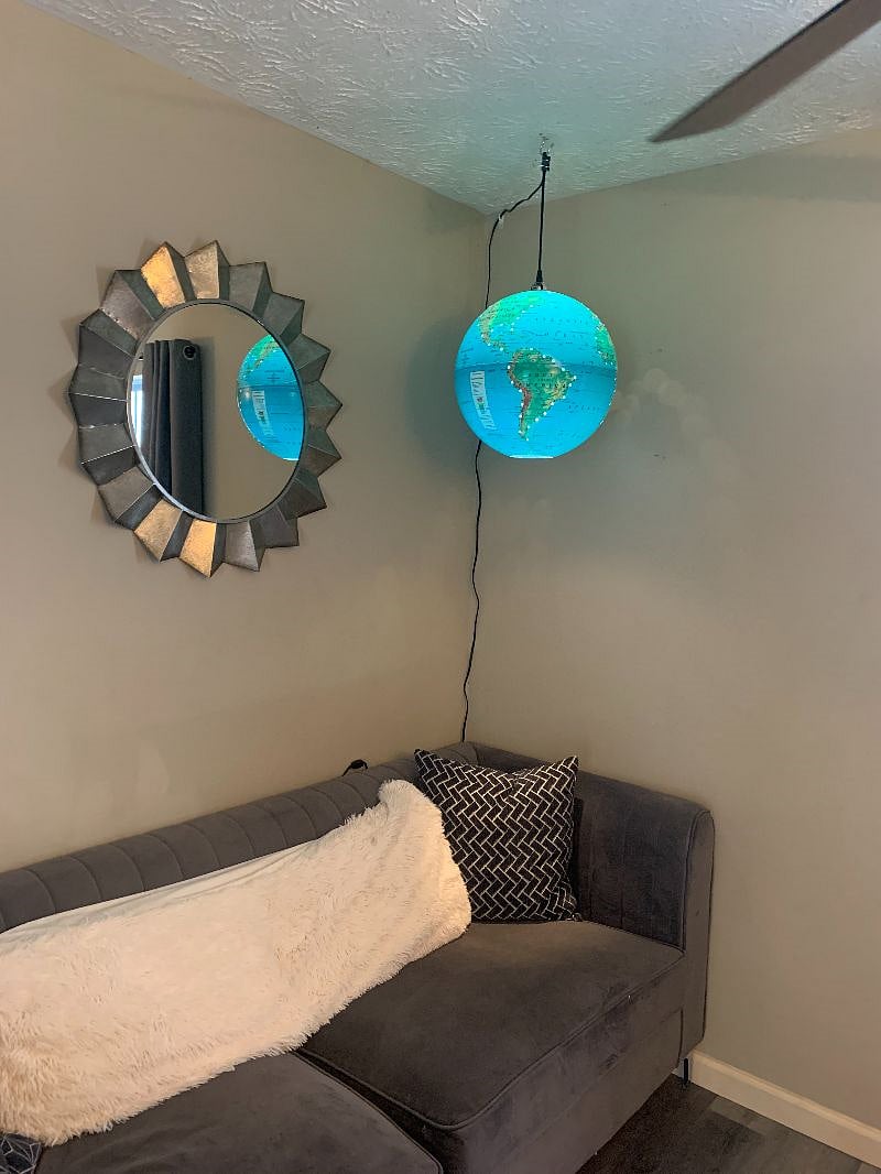 Living room area. Globe Light over couch. 
