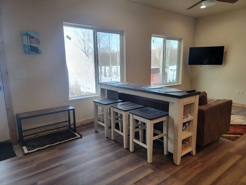 View of living room as you walk in the door.  Heated floors throughout the apartment.