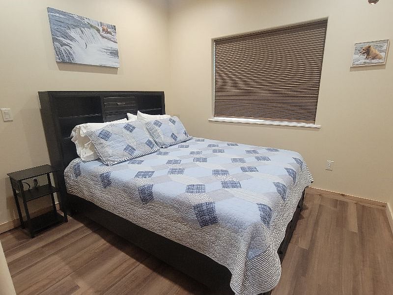 Bedroom 1 with queen size bed and darkening shade.