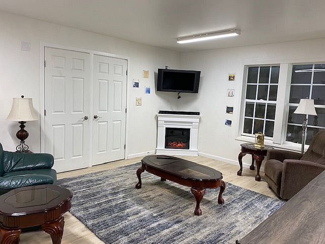 Living room with comfortable chairs, electric fireplace and TV.