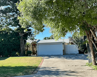 Front of property - entrance to guest unit through White Gate to the right of the garage.