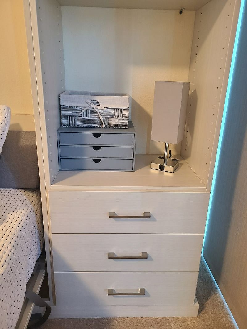 More storage space for smaller items and drawers. Lamp has outlets/USB ports for easy access.