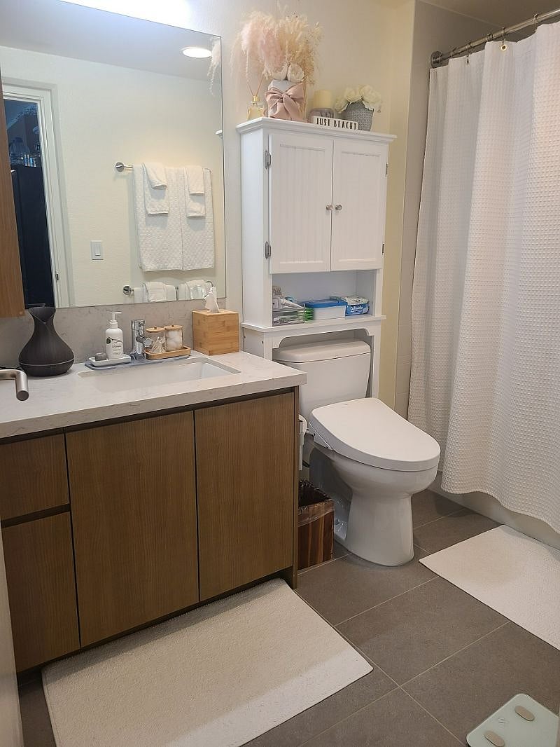 This is the guest bathroom just down the hall from the guest room equipped with a Toto Bidet and toiletries in the cabinets.
