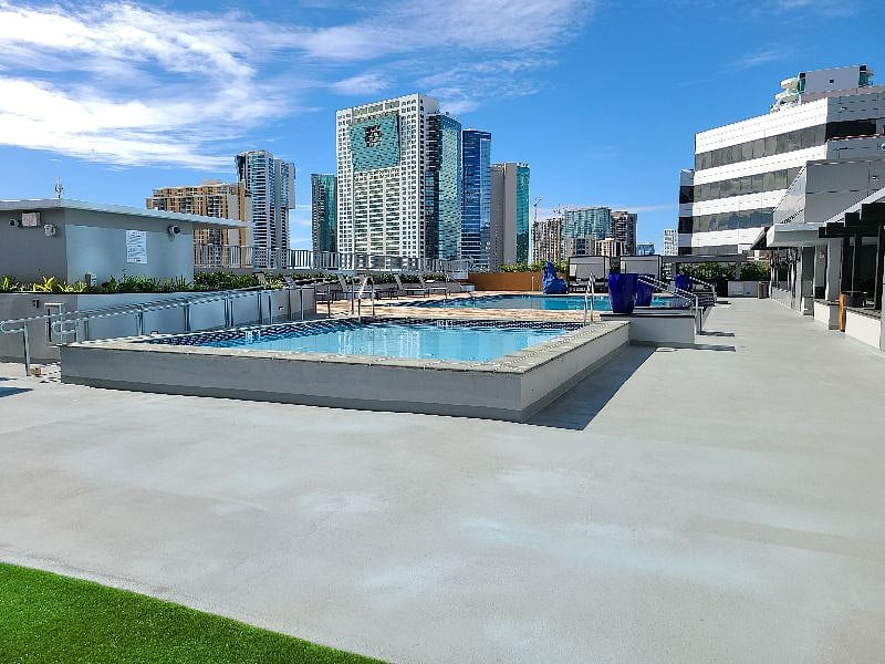Here's the amenity deck with an adult pool, kid's pool, kid's playground, jacuzzi, BBQ cabanas, workout facility, and party room.