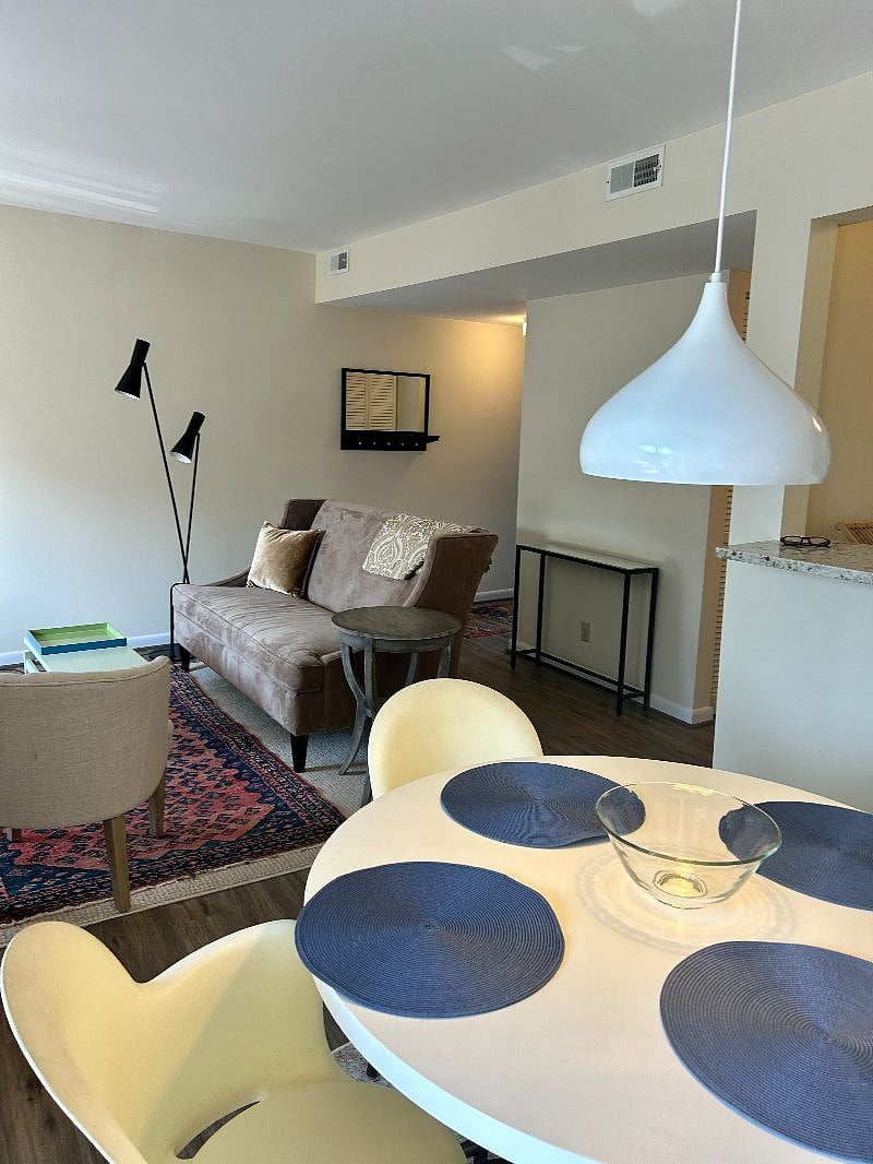 Living area with fireplace, smart TV, next to dining and balcony