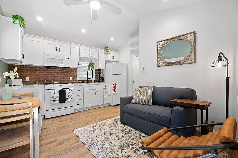 The loveseat opens up to a single bed.
Wood vinyl flooring, and mounted TV