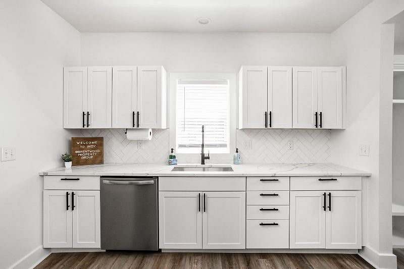 Stylish cabinets, a sleek sink, and a convenient dishwasher for a seamless and sophisticated culinary experience.
